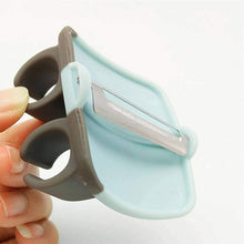 Hand palm vegetable peeler with rubber grip.